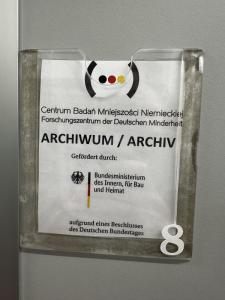 The name of the archive, placed on a shelving unit in the GMRC archives